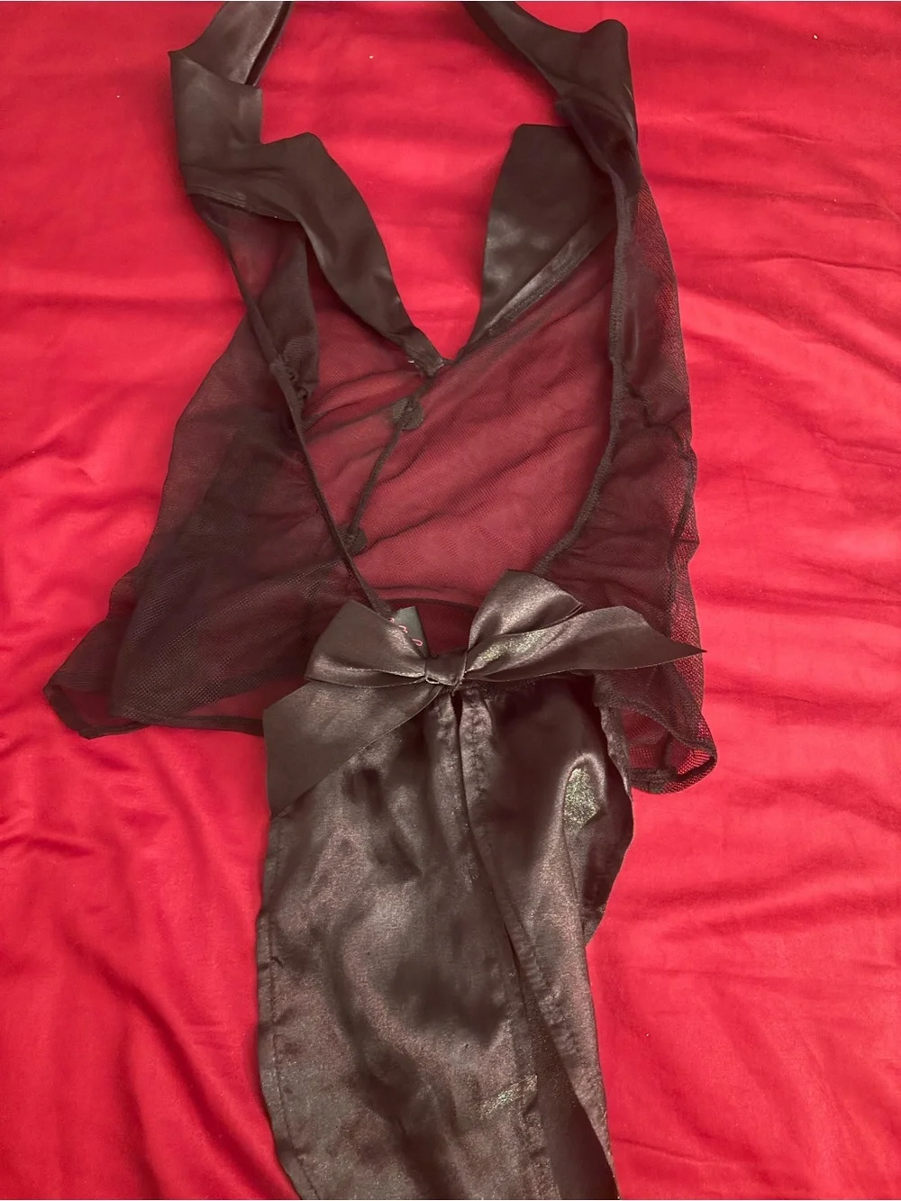 Black ruffled lingerie set with ruffed panty and sheer top.  Top i